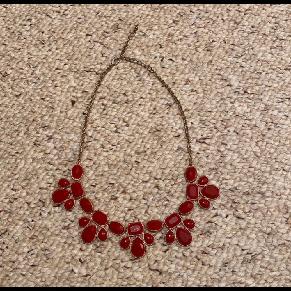 Three different statement necklaces (red, orange, teal blue)